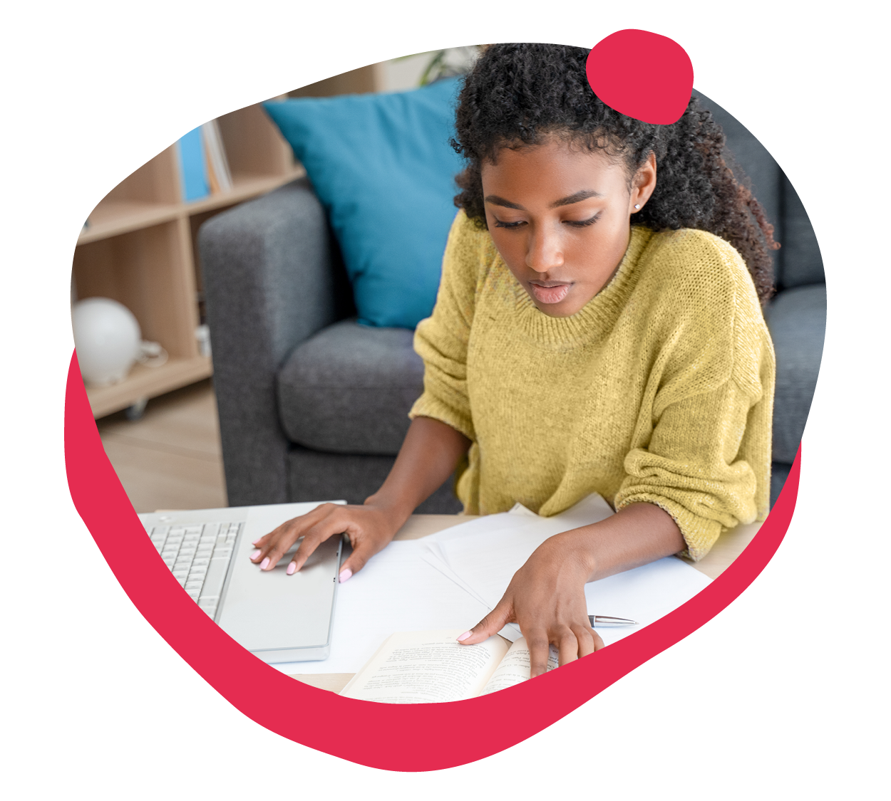 young woman studying at a laptop with papers and a book in a cozy living space, focused learning and productivity in home office