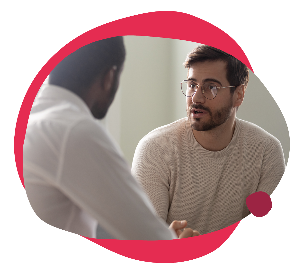 casual conversation between two men, one wearing glasses, in a modern setting, engaging dialogue with a focus on collaboration