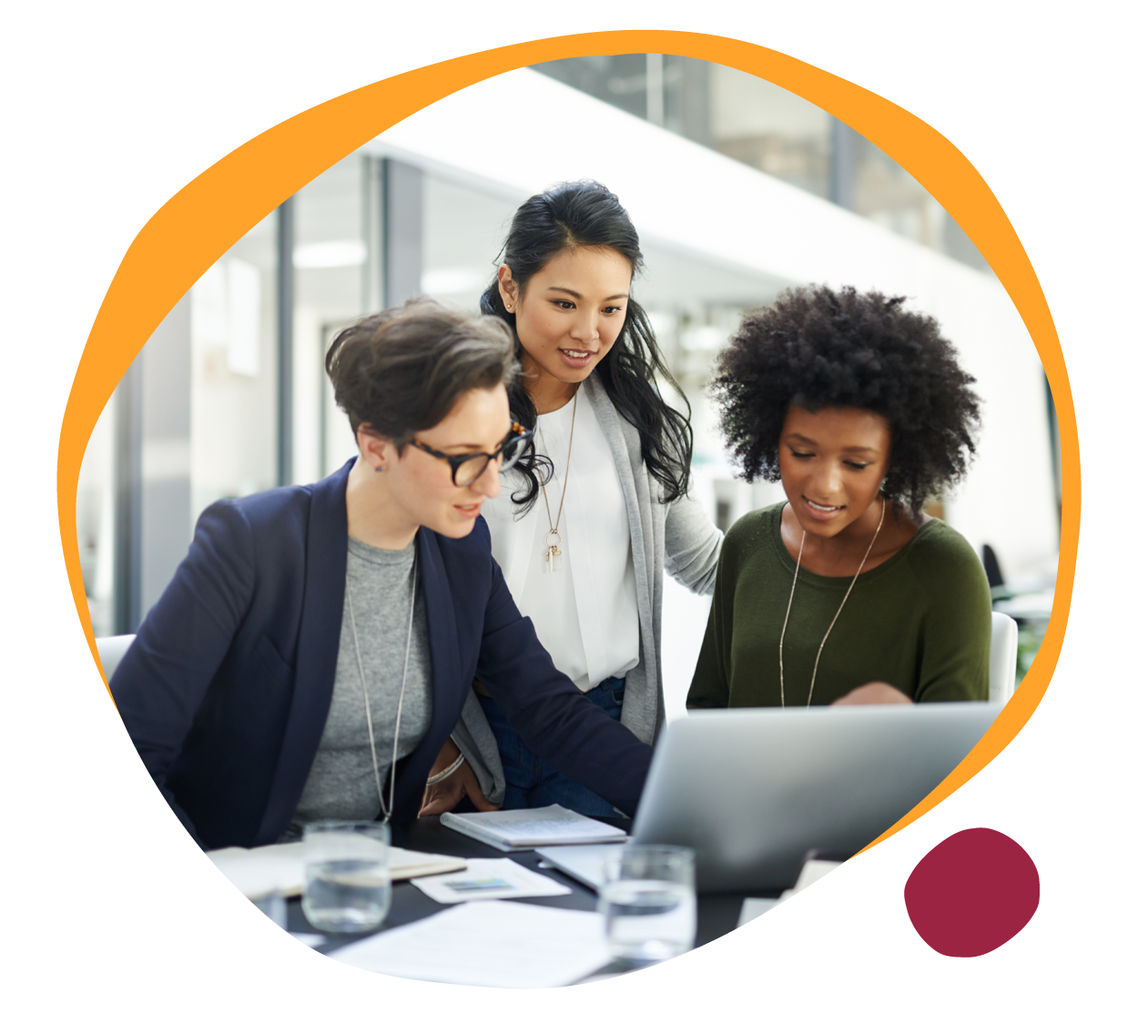 collaborative women analyzing data on laptop, diverse professionals engaged in teamwork in modern workspace