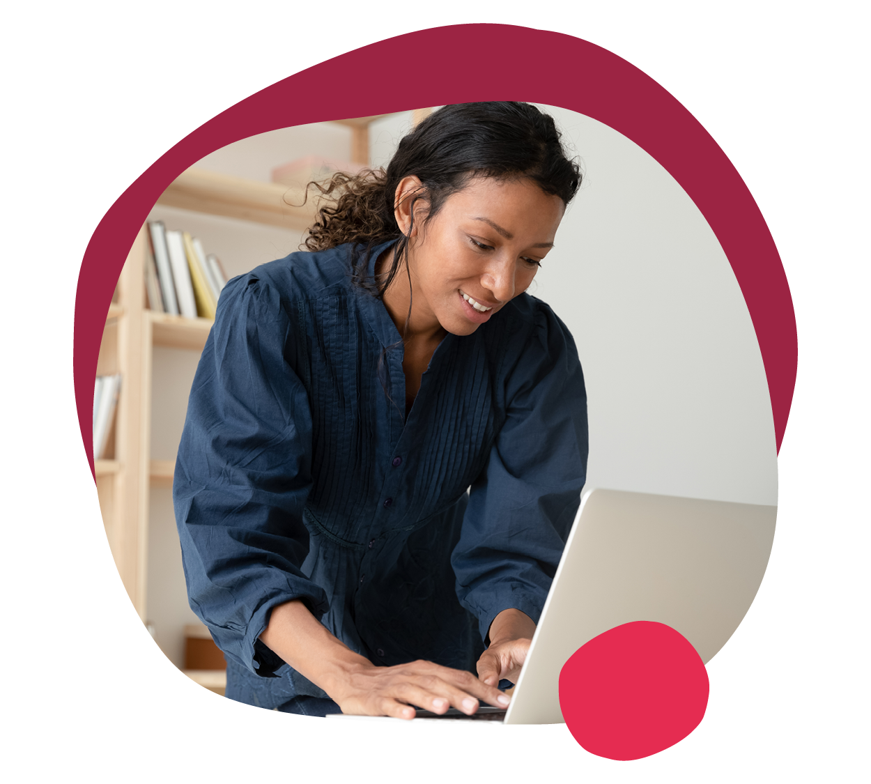 focused woman working on laptop in a minimalistic workspace with bookshelves in the background, remote work productivity