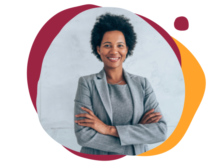 professional woman smiling in a gray suit with crossed arms against a light background, confident business attire and friendly demeanor