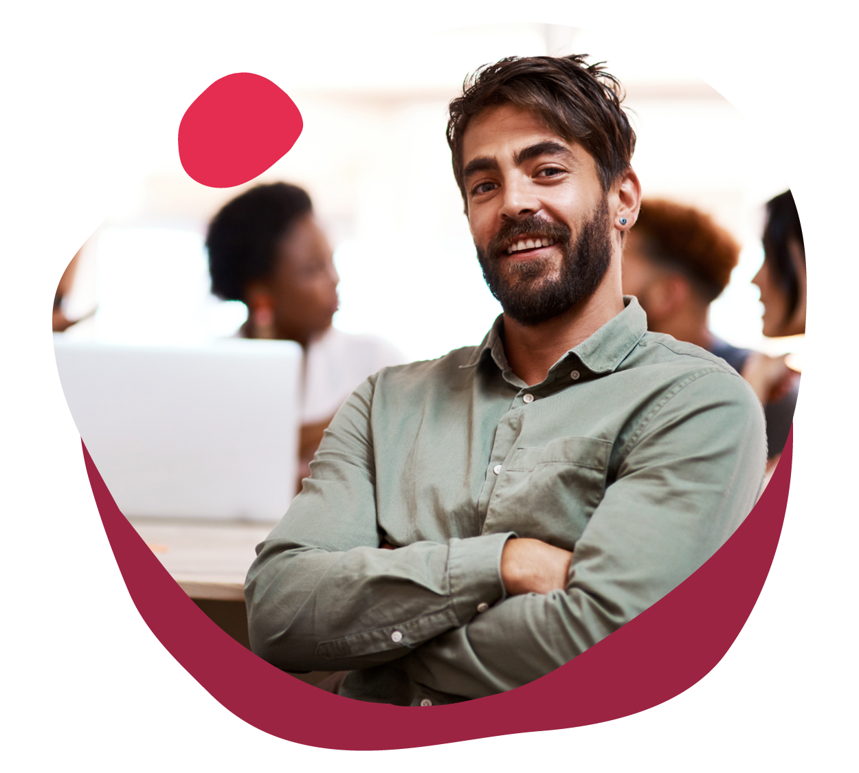 confident man smiling in a workplace setting with coworkers, professional atmosphere promoting collaboration and teamwork