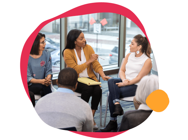 diverse group discussion, women engaging in conversation during a meeting