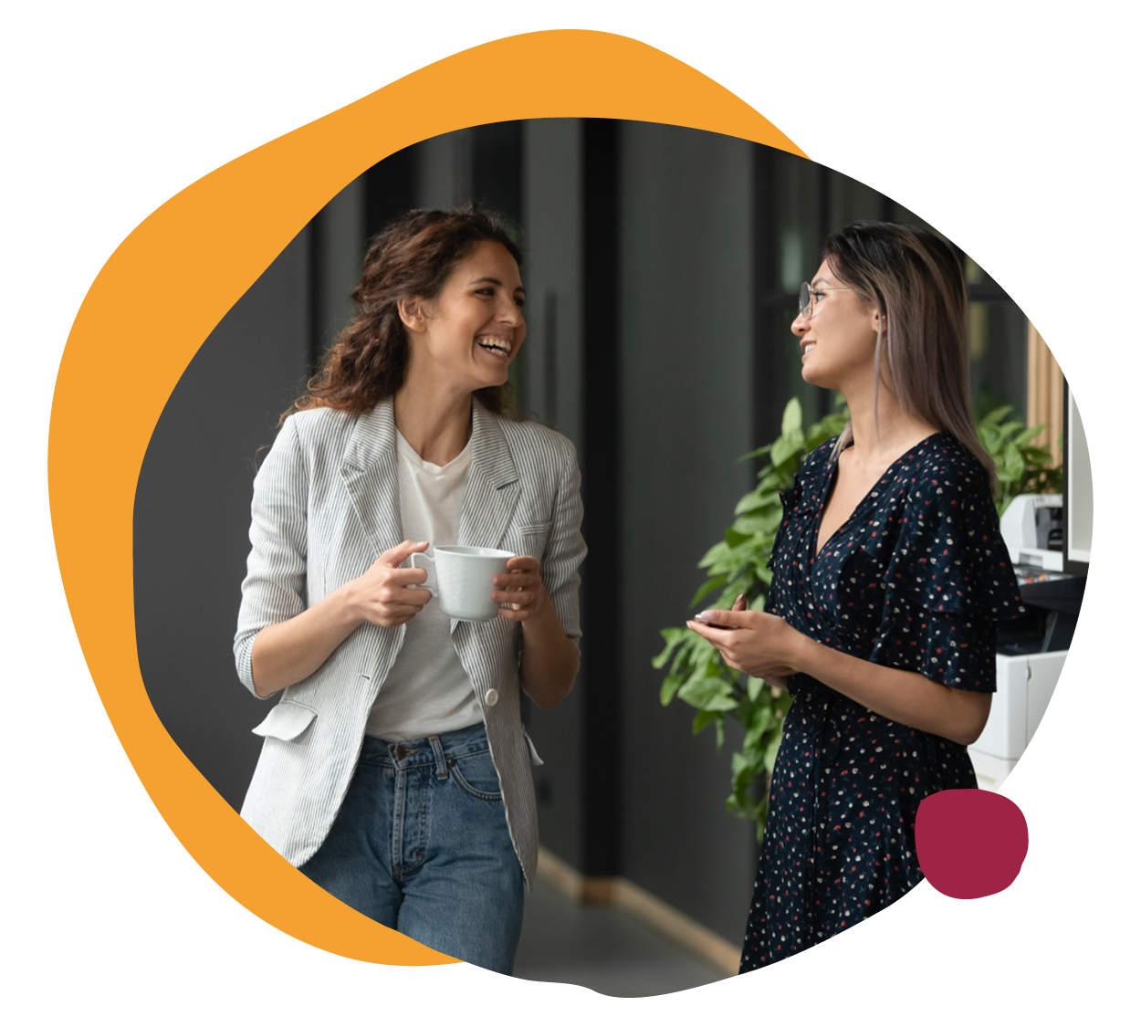 smiling-women-casual-office-conversation, coffee-break-casual-attire-modern-workspace