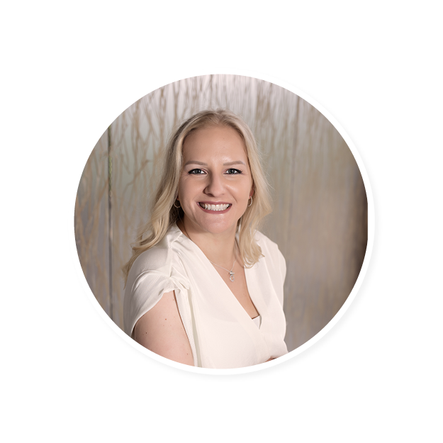smiling woman with long blonde hair in white blouse against soft abstract backdrop, professional portrait with natural lighting