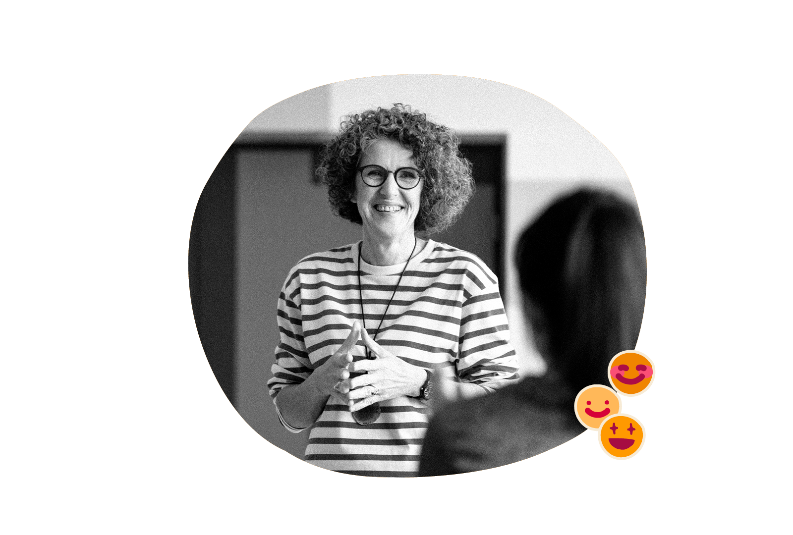 smiling woman in striped shirt engaging with audience in a bright room, workshop atmosphere with cheerful emoji reactions