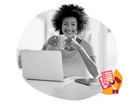 woman with curly hair smiling at laptop, holding coffee cup, home office setting with documents on table