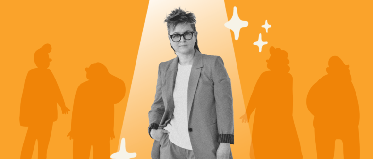 businesswoman in stylish suit under spotlight with silhouettes of people and bright orange background, confident female leader in modern setting