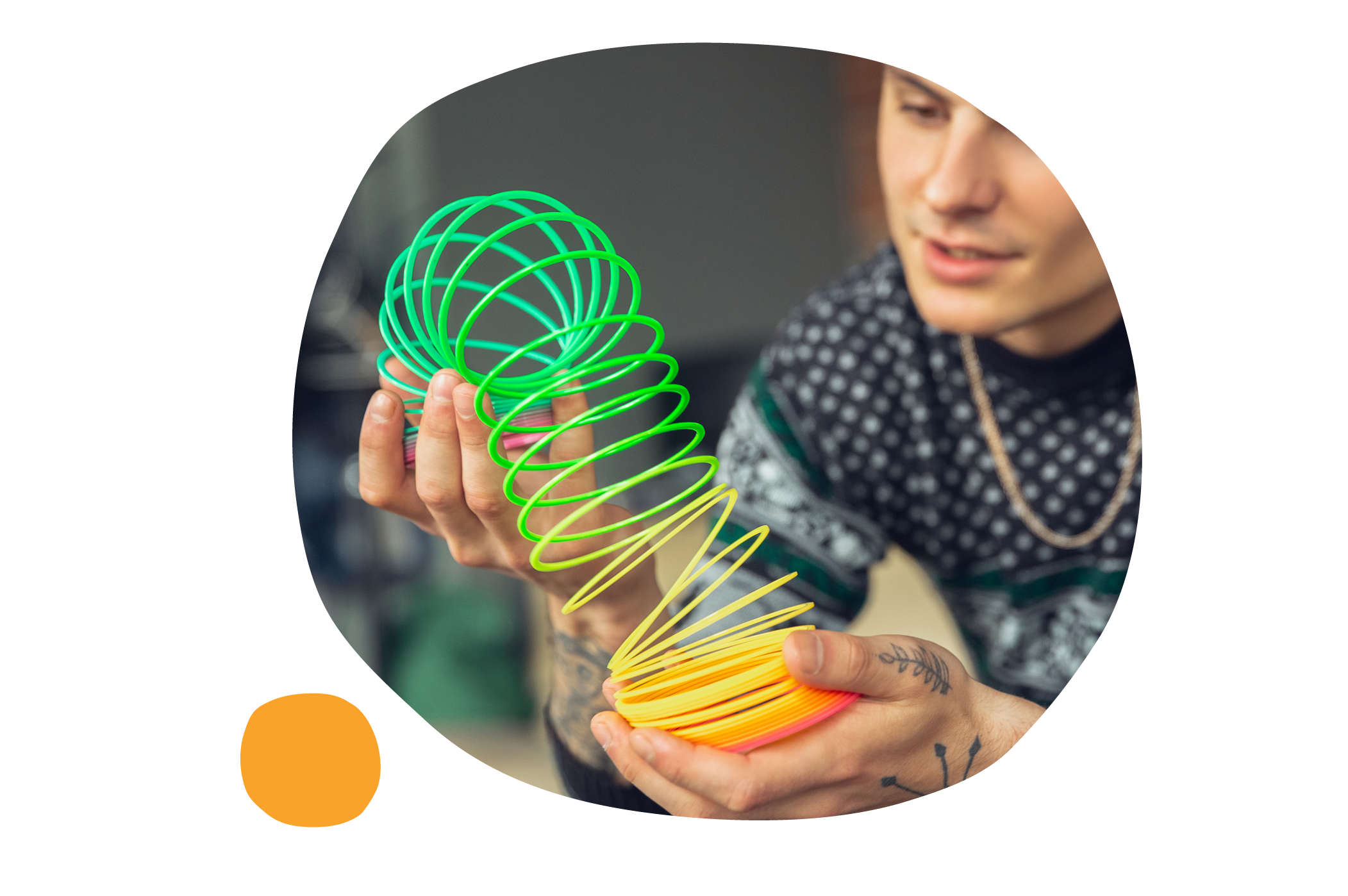 colorful spring toy, person holding spring toy in hands