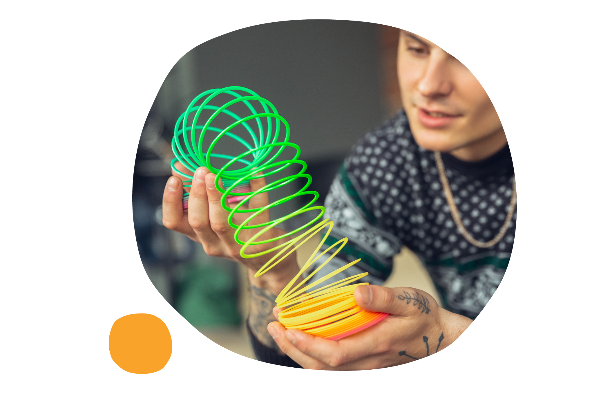 colorful spring toy, person holding spring toy in hands