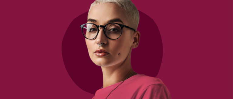 stylish short-haired person in glasses and a pink top against a maroon background, modern portrait with trendy accessories and style