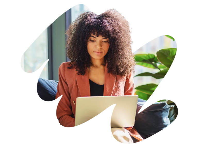 woman working on laptop, cozy indoor workspace with plants