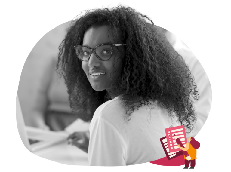 woman with curly hair and glasses smiling while working on a laptop, focused on creativity and learning or collaboration theme