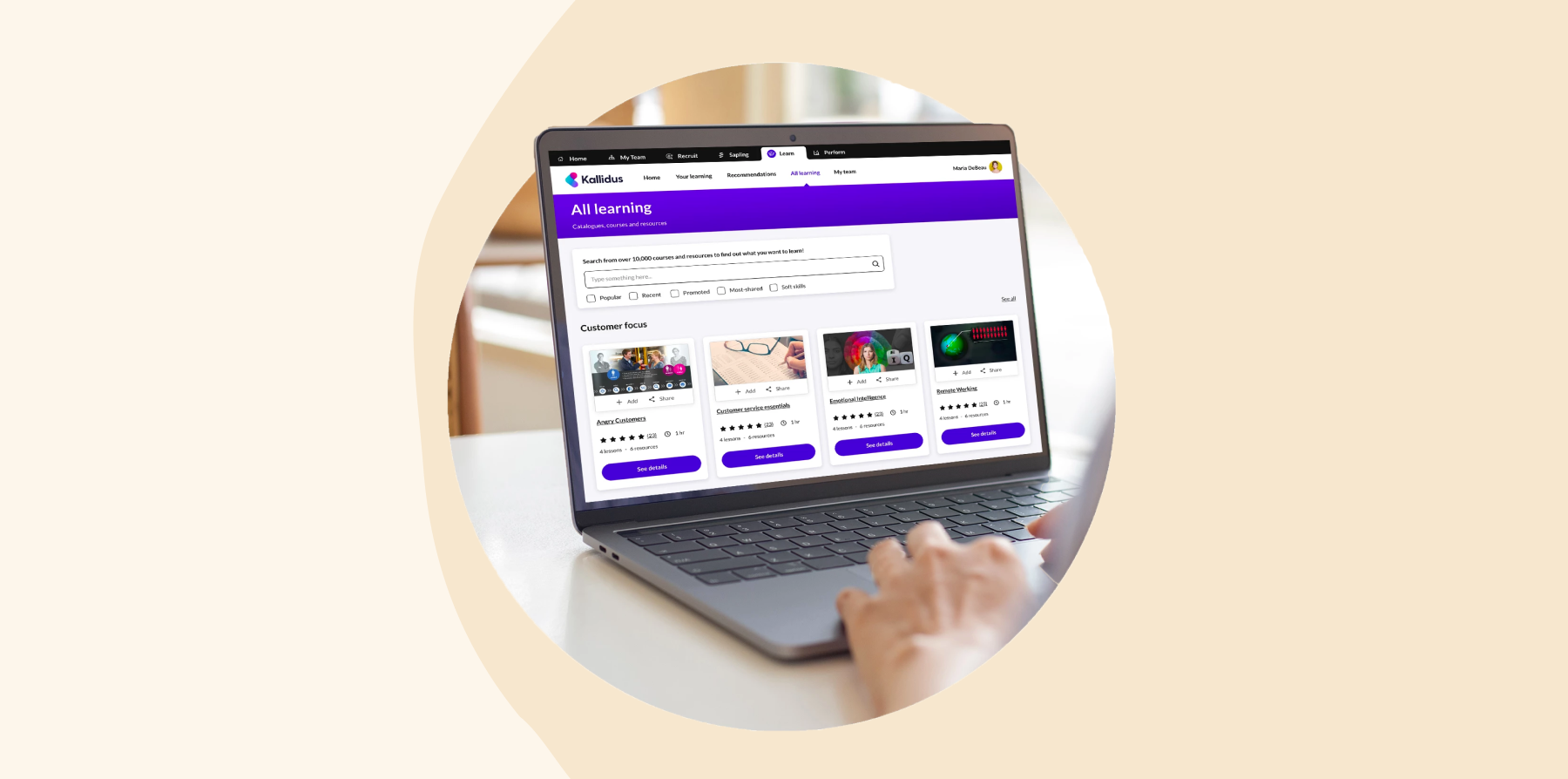 User browsing Kallidus LMS interface on a laptop, featuring a purple-themed learning dashboard and course tiles.