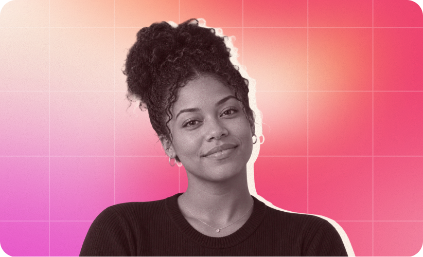 smiling woman with curly hair in black sweater against vibrant pink background, confident expression with soft lighting effects