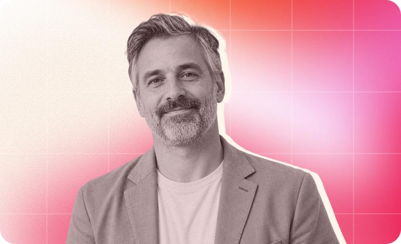 smiling man in blazer with gray hair against gradient pink background, portrait of confident professional male in casual attire