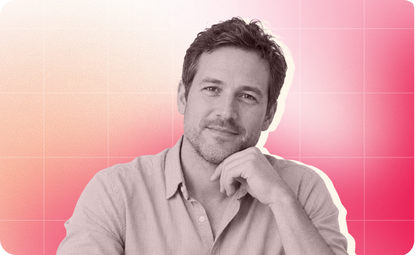 man with short hair and beard in a light shirt, smiling thoughtfully against a gradient pink background, thoughtful man portrait image