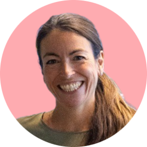smiling woman with long hair in a round frame against a pink background, bright smile and friendly expression in a casual setting
