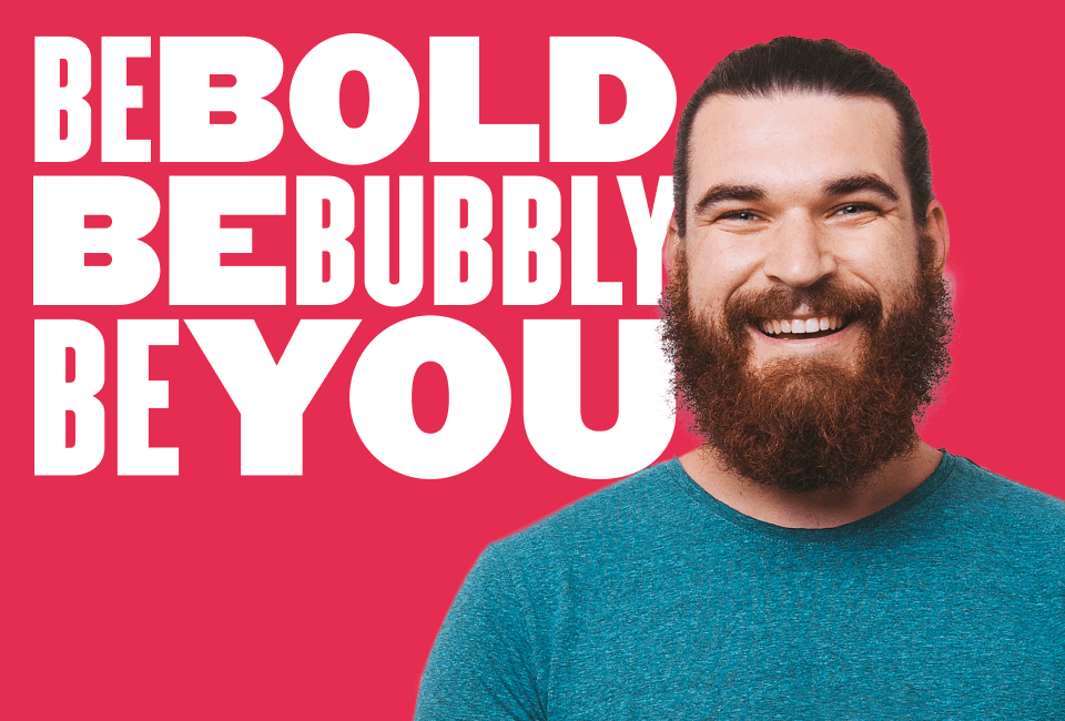 BE BOLD and BE BUBBLY text with a smiling man in a blue shirt on a vibrant pink background. Positive and motivational vibe. bold, bubbly